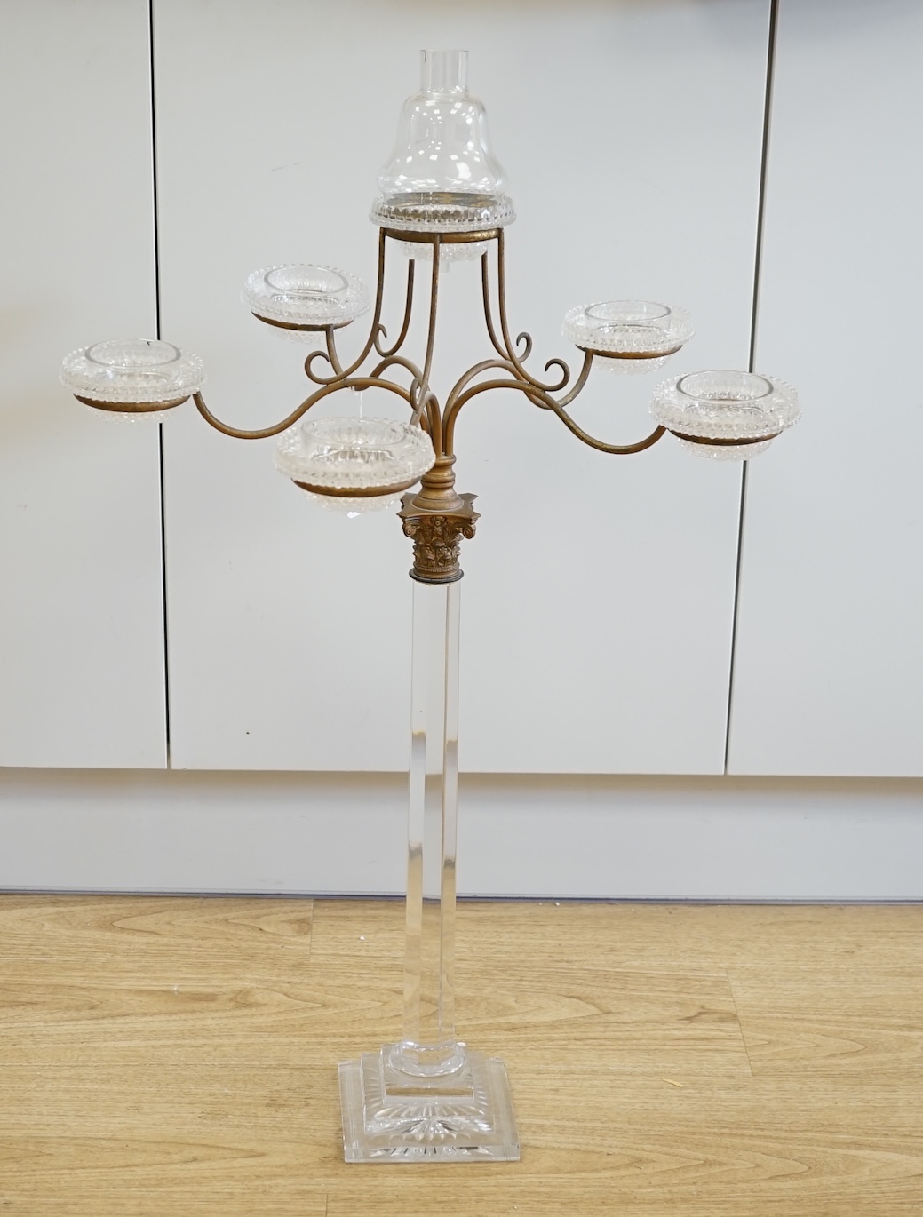 A Victorian glass and brass Corinthian column five branch, six light epergne centrepiece, 83.5cm high. Condition - slight chip to one corner of the base and funnel to top light chipped